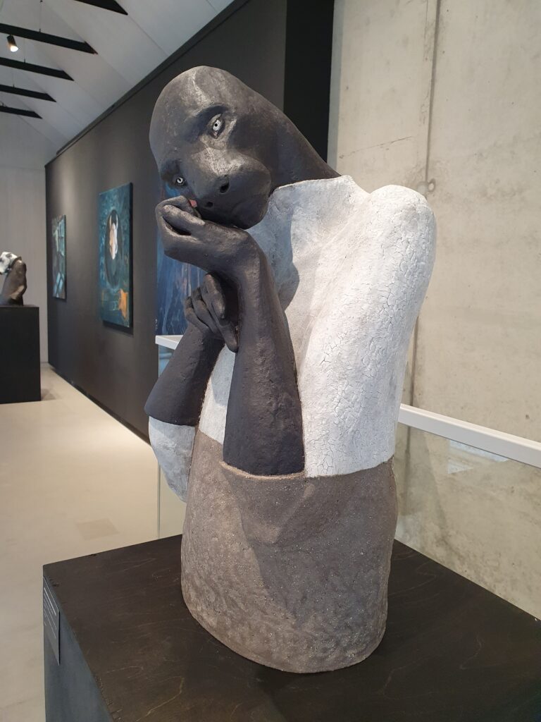 A stoneware sculpture of a mythical creature in the appearance of a panther